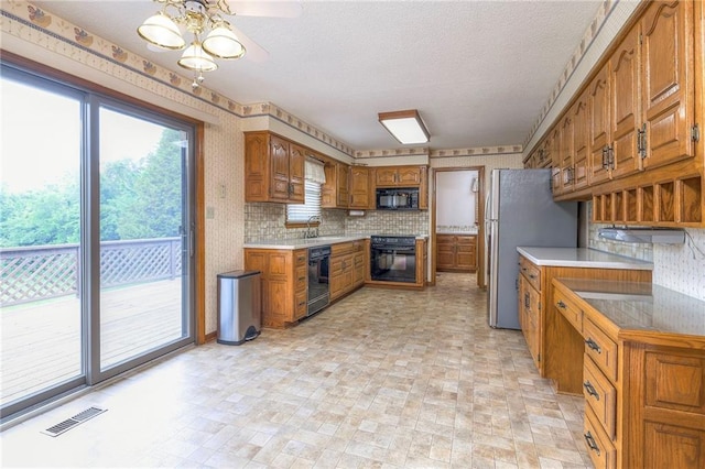 25908 Colbern Rd, Lees Summit, MO 64086 - kitchen featuring black appliances, brown cabinetry, ceiling fan, a sink, and wallpapered walls
