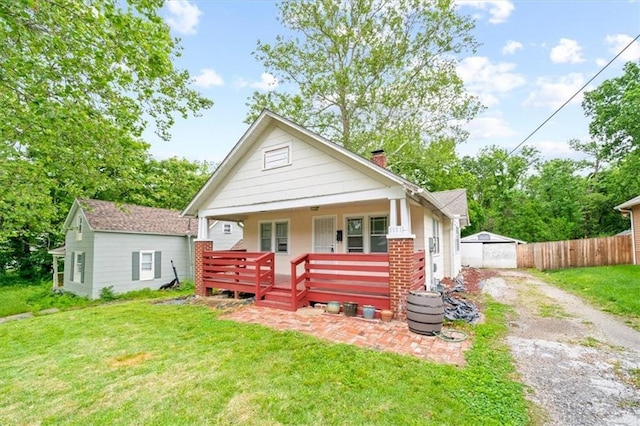 1111 S Cottage St, Independence, MO 64050 - bungalow-style home featuring dirt driveway, a chimney, and brick siding