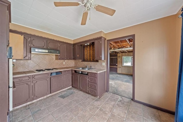 1111 S Cottage St, Independence, MO 64050 - kitchen featuring under cabinet range hood, white gas stovetop, light countertops, ceiling fan, and a sink