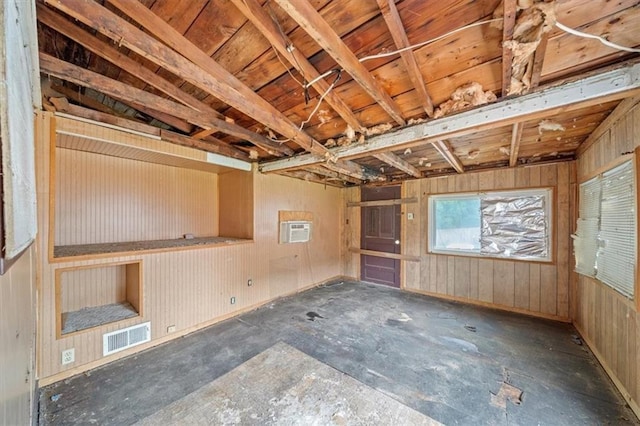 1111 S Cottage St, Independence, MO 64050 - unfurnished room featuring a wall mounted AC and wooden walls