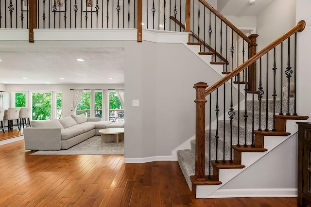 8911 W 104th St, Overland Park, KS 66212 - stairway featuring hardwood / wood-style floors, baseboards, and recessed lighting