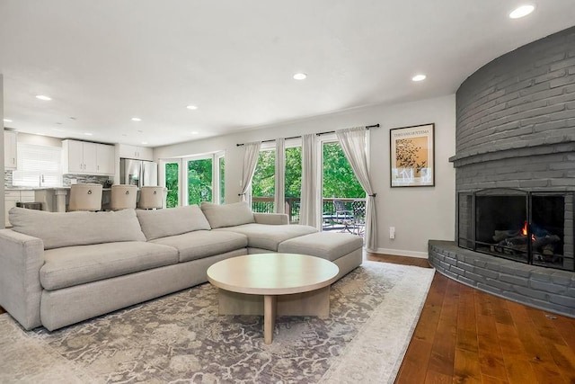 8911 W 104th St, Overland Park, KS 66212 - living area featuring hardwood / wood-style flooring, recessed lighting, a fireplace, and baseboards