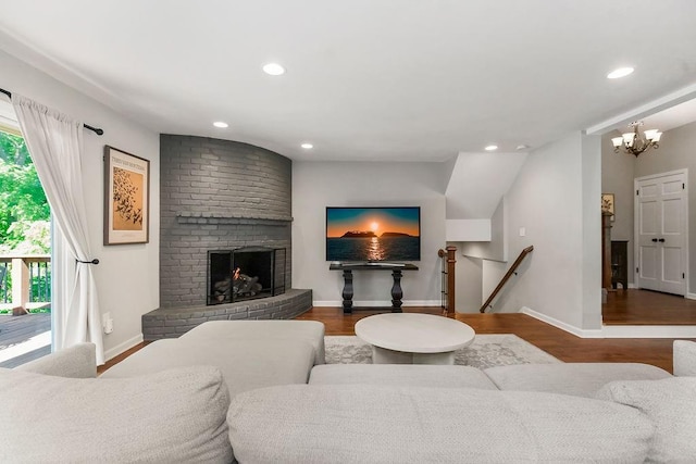 8911 W 104th St, Overland Park, KS 66212 - living room featuring wood finished floors, a chandelier, baseboards, recessed lighting, and a fireplace
