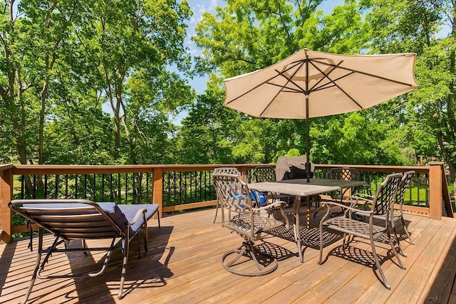 8911 W 104th St, Overland Park, KS 66212 - wooden terrace featuring outdoor dining area and view of wooded area