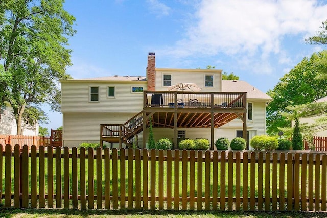 8911 W 104th St, Overland Park, KS 66212 - back of house featuring a wooden deck, stairway, and a chimney