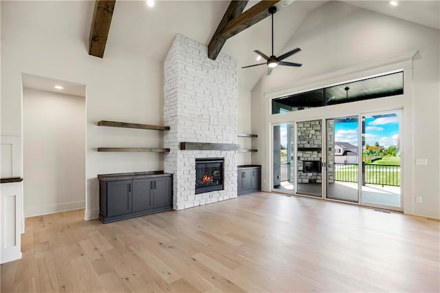 17556 Acton St, Overland Park, KS 66085 - unfurnished living room featuring a fireplace, high vaulted ceiling, ceiling fan, light wood finished floors, and beam ceiling