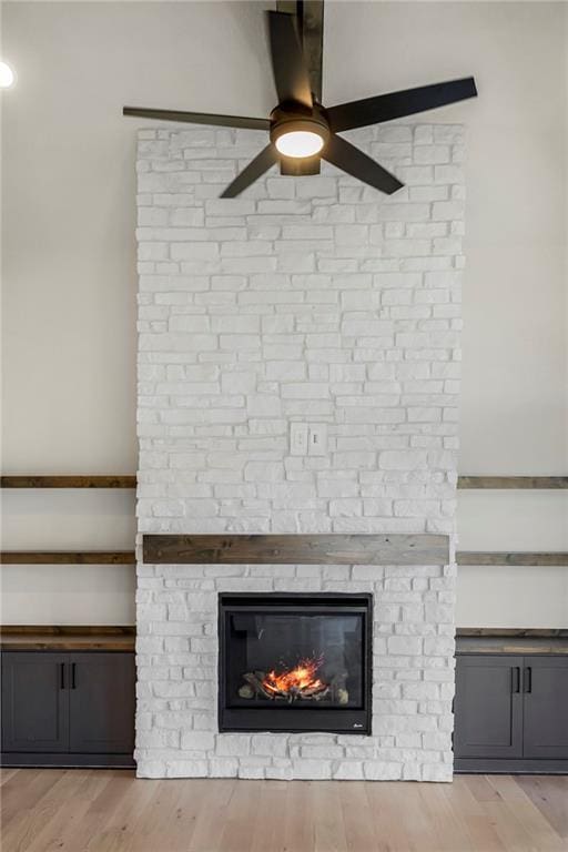 17556 Acton St, Overland Park, KS 66085 - detailed view of a ceiling fan, a fireplace, and wood finished floors