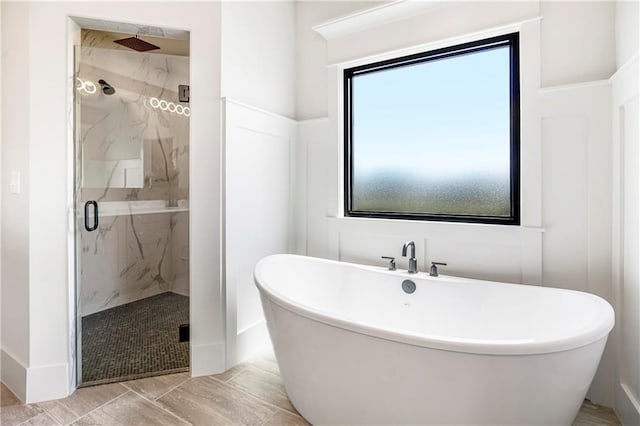 17556 Acton St, Overland Park, KS 66085 - full bathroom featuring a marble finish shower and a freestanding bath