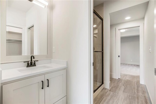17556 Acton St, Overland Park, KS 66085 - full bathroom with a stall shower, vanity, a spacious closet, and recessed lighting