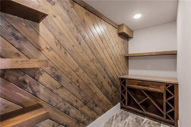 17556 Acton St, Overland Park, KS 66085 - wine room featuring marble look tiles and wood walls