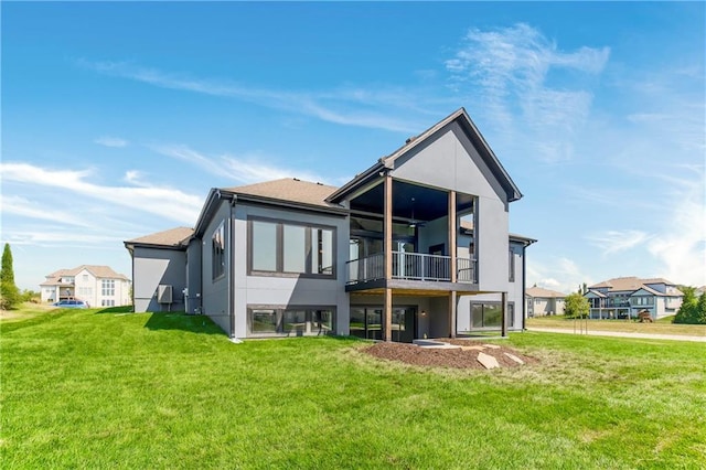 17556 Acton St, Overland Park, KS 66085 - rear view of house with a lawn, stucco siding, and a balcony