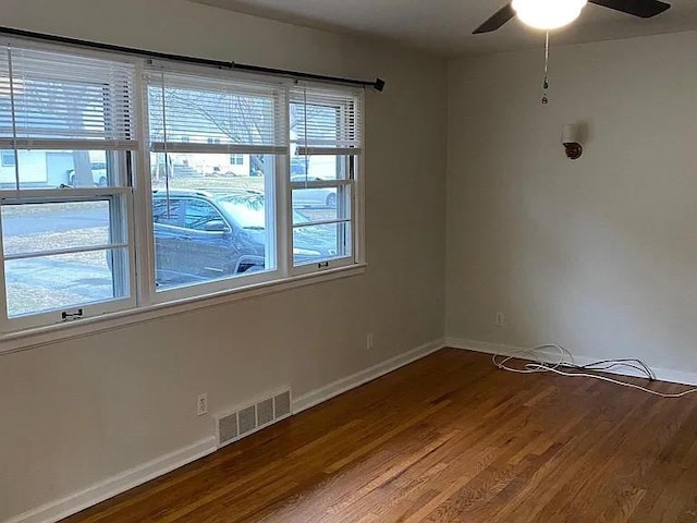 5333 Outlook St, Mission, KS 66202 - spare room with a ceiling fan, wood finished floors, and baseboards