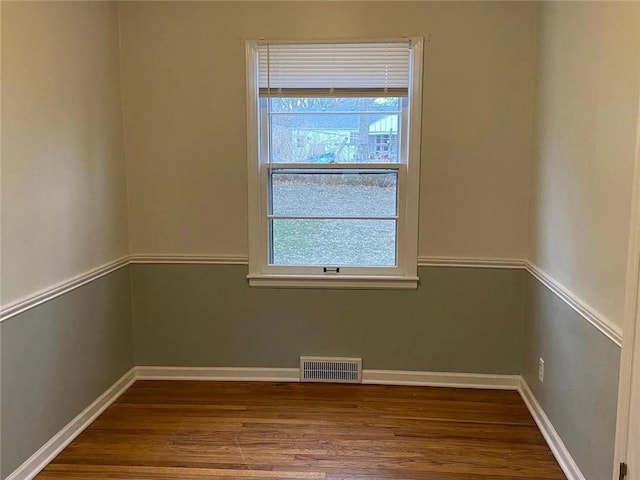 5333 Outlook St, Mission, KS 66202 - unfurnished room featuring plenty of natural light, wood finished floors, and baseboards