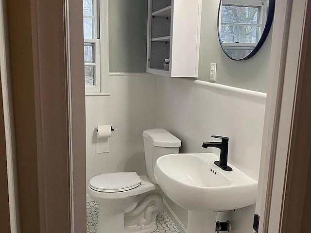 5333 Outlook St, Mission, KS 66202 - half bathroom with toilet, tile patterned flooring, and a sink