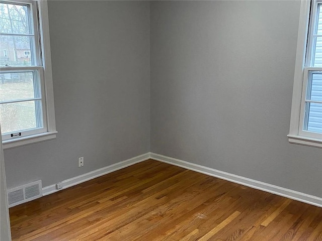 5333 Outlook St, Mission, KS 66202 - unfurnished room with wood finished floors, baseboards, and healthy amount of natural light