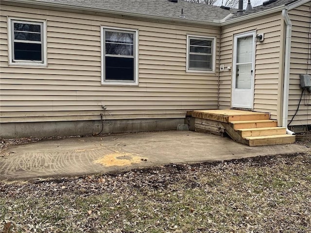 5333 Outlook St, Mission, KS 66202 - entrance to property featuring a shingled roof and a patio