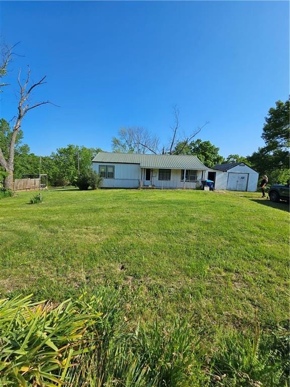 W 83rd St Unit 30720, De Soto, KS 66018 - back of property featuring a lawn and a garage
