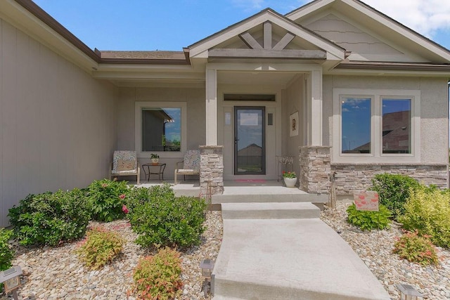 9305 SW Sushi Cir, Lees Summit, MO 64064 - doorway to property featuring covered porch and stone siding