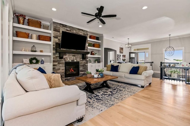 9305 SW Sushi Cir, Lees Summit, MO 64064 - living area with crown molding, wood finished floors, ceiling fan, a fireplace, and recessed lighting