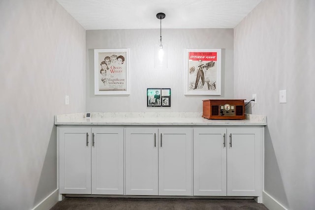 9305 SW Sushi Cir, Lees Summit, MO 64064 - bar area featuring baseboards and pendant lighting