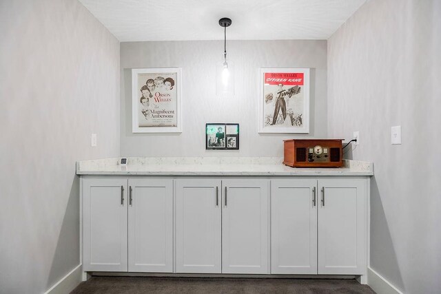 9305 SW Sushi Cir, Lees Summit, MO 64064 - bar with baseboards and hanging light fixtures