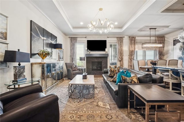 15278 W 173rd St, Olathe, KS 66062 - living room with a chandelier, a glass covered fireplace, wood finished floors, and crown molding