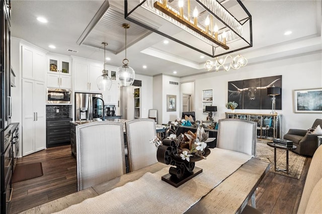 15278 W 173rd St, Olathe, KS 66062 - dining space with a raised ceiling, dark wood-style flooring, recessed lighting, and a chandelier
