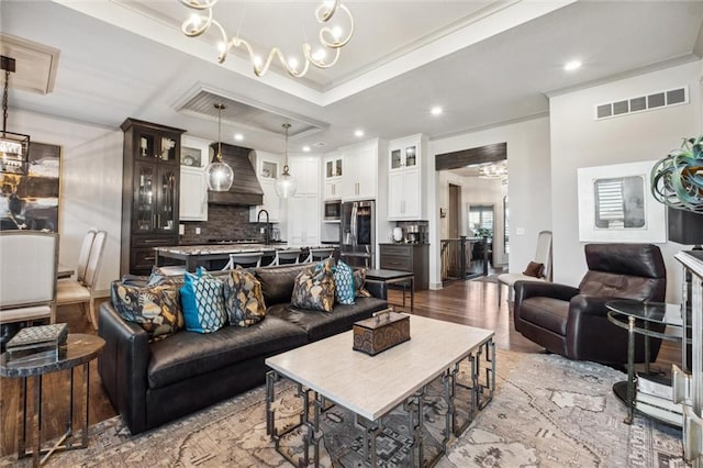 15278 W 173rd St, Olathe, KS 66062 - living room featuring a chandelier, ornamental molding, wood finished floors, and recessed lighting