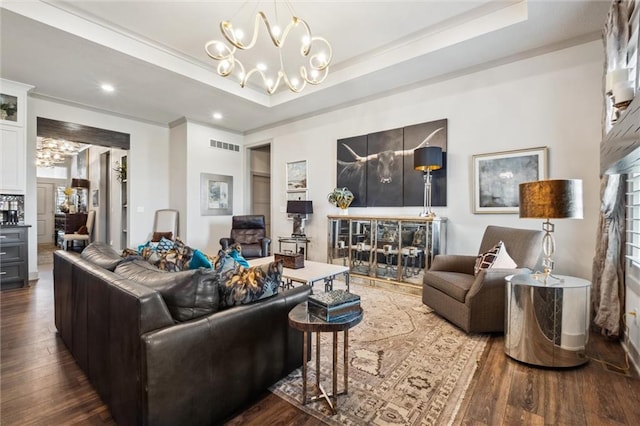 15278 W 173rd St, Olathe, KS 66062 - living area featuring a chandelier, dark wood finished floors, a raised ceiling, ornamental molding, and recessed lighting
