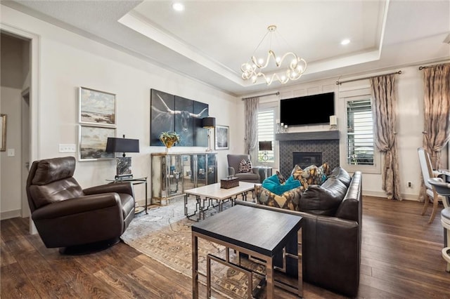 15278 W 173rd St, Olathe, KS 66062 - living area featuring a raised ceiling, wood finished floors, a glass covered fireplace, and recessed lighting