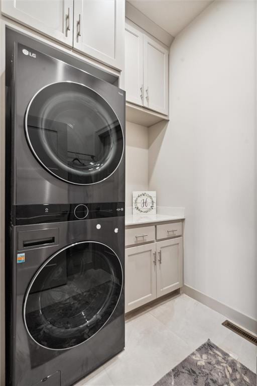 15278 W 173rd St, Olathe, KS 66062 - washroom with stacked washer / dryer, cabinet space, and baseboards