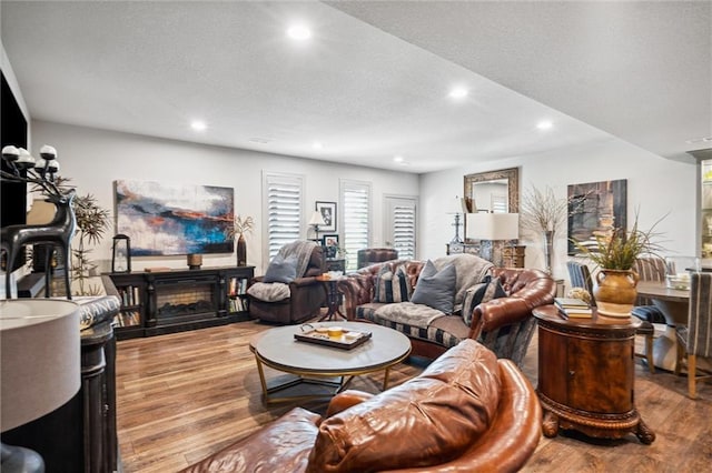 15278 W 173rd St, Olathe, KS 66062 - living area with recessed lighting, wood finished floors, a textured ceiling, and a fireplace