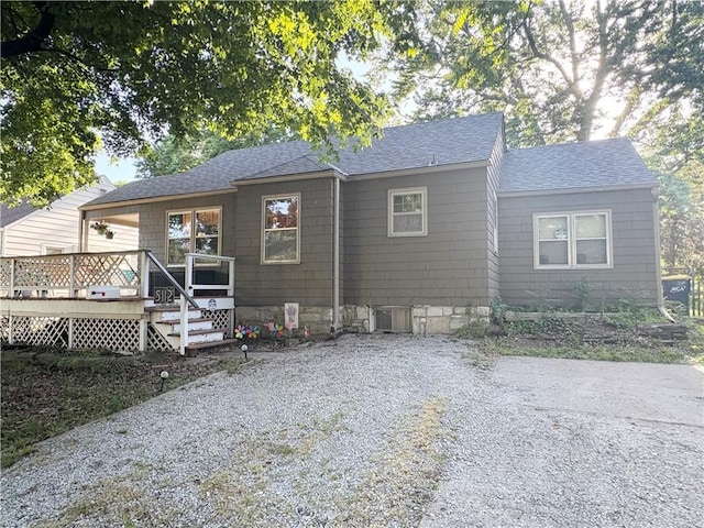5112 Maple St, Mission, KS 66202 - view of front facade featuring a shingled roof and a deck