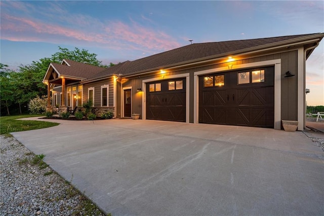 9425 NE 188th St, Trimble, MO 64492 - view of front of house featuring driveway, an attached garage, and stone siding