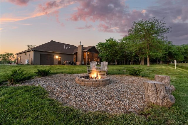 9425 NE 188th St, Trimble, MO 64492 - view of green lawn with an outdoor fire pit and an attached garage