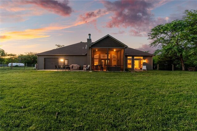 9425 NE 188th St, Trimble, MO 64492 - rear view of house with a sunroom, a chimney, and an attached garage