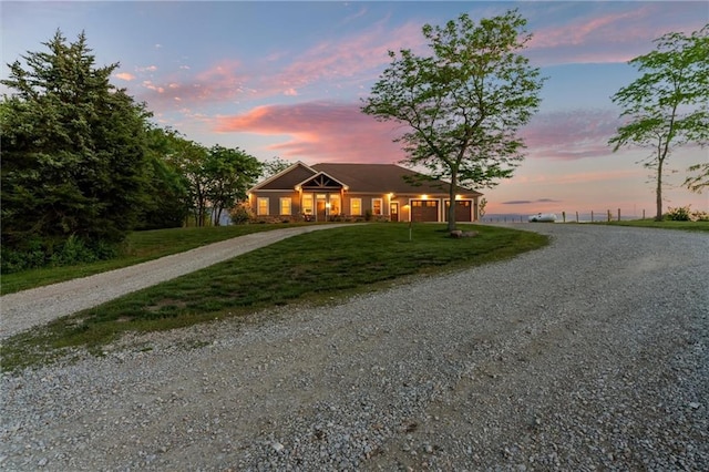 9425 NE 188th St, Trimble, MO 64492 - ranch-style house with curved driveway, a front yard, and a garage
