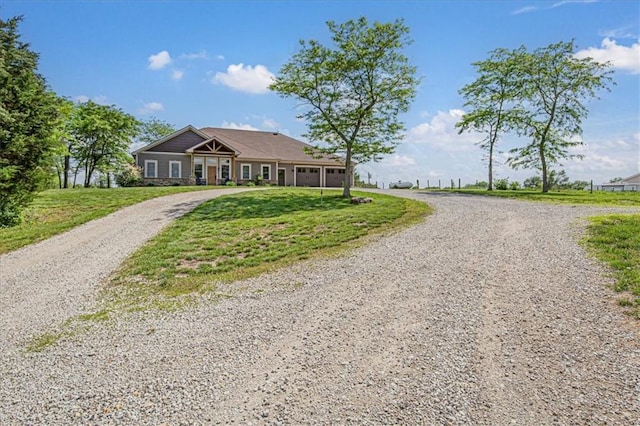 9425 NE 188th St, Trimble, MO 64492 - view of front facade featuring a garage, gravel driveway, and a front lawn