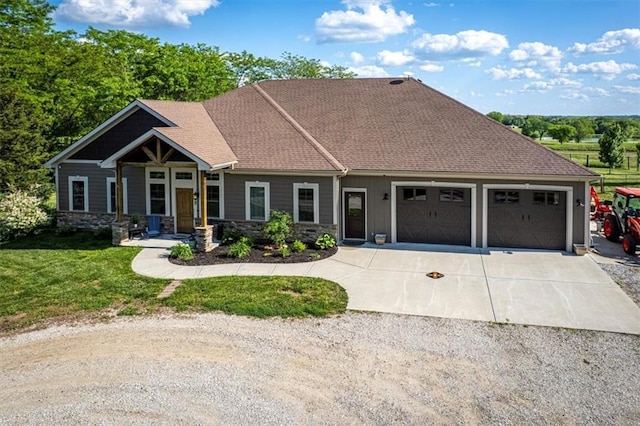 9425 NE 188th St, Trimble, MO 64492 - view of front facade featuring an attached garage, concrete driveway, a front lawn, and stone siding