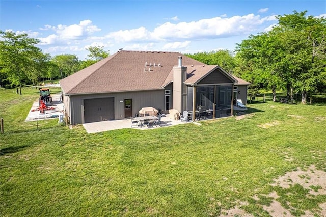 9425 NE 188th St, Trimble, MO 64492 - back of property featuring a patio, a sunroom, a yard, a chimney, and an attached garage