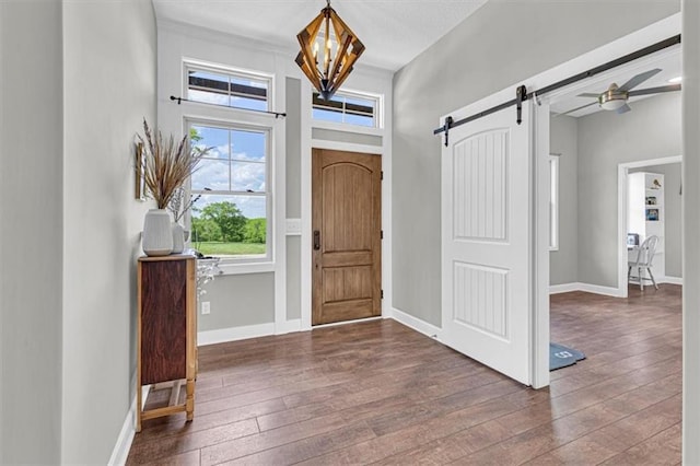 9425 NE 188th St, Trimble, MO 64492 - entrance foyer featuring a barn door, hardwood / wood-style flooring, and a chandelier