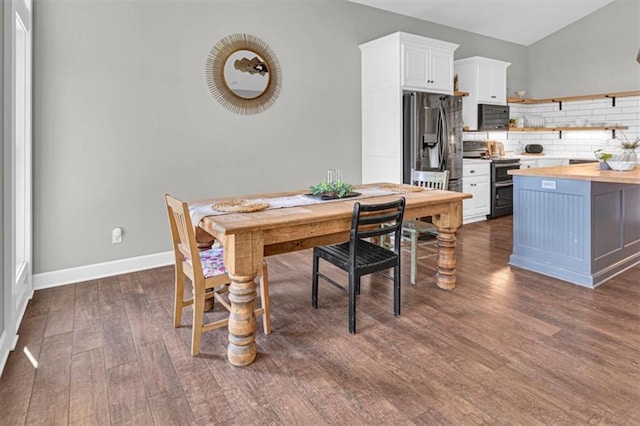 9425 NE 188th St, Trimble, MO 64492 - dining area featuring dark wood finished floors and vaulted ceiling