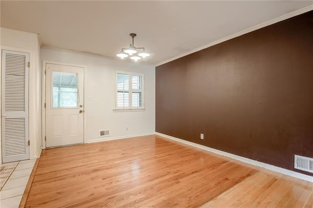 15609 E 43rd St S, Independence, MO 64055 - unfurnished dining area with light wood finished floors, a chandelier, crown molding, and baseboards