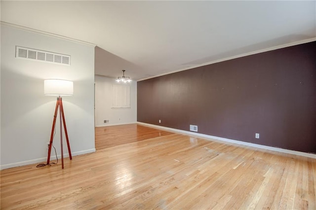 15609 E 43rd St S, Independence, MO 64055 - spare room with a chandelier, light wood-style flooring, ornamental molding, and baseboards