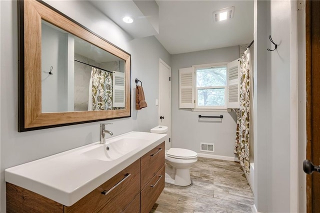 15609 E 43rd St S, Independence, MO 64055 - full bathroom featuring vanity, wood finished floors, toilet, baseboards, and a shower with shower curtain