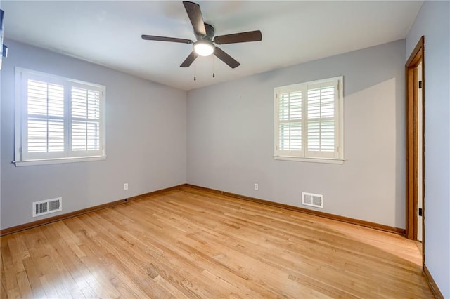 15609 E 43rd St S, Independence, MO 64055 - empty room with healthy amount of natural light, light wood-type flooring, baseboards, and a ceiling fan
