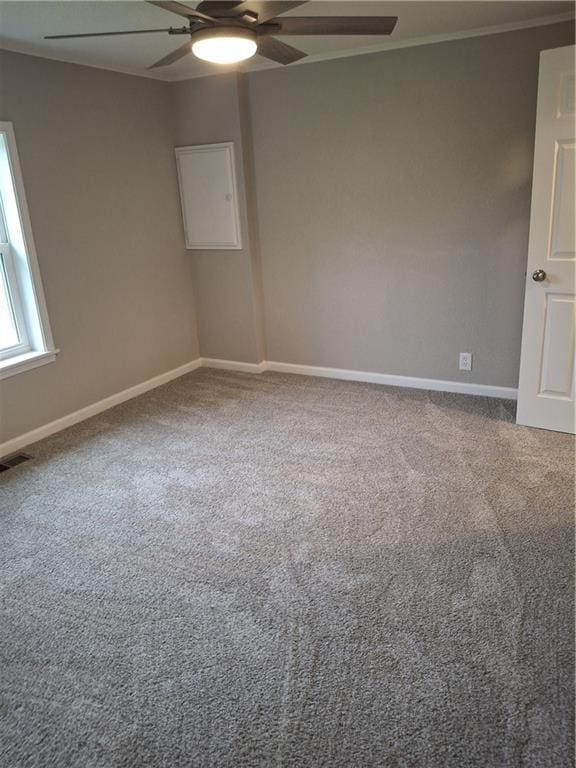 715 E Blackhawk St, Ottawa, KS 66067 - spare room featuring a ceiling fan, carpet flooring, baseboards, and ornamental molding