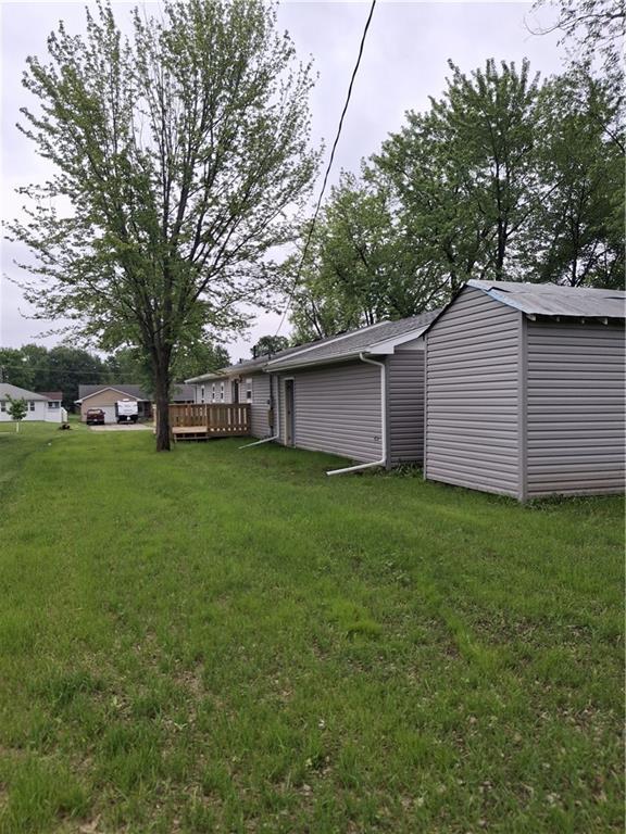 715 E Blackhawk St, Ottawa, KS 66067 - view of green lawn featuring a wooden deck