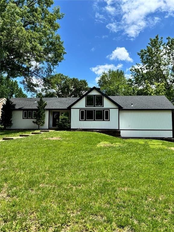 1702 Countryside Dr, Pittsburg, KS 66762 - back of house featuring a lawn and a shingled roof