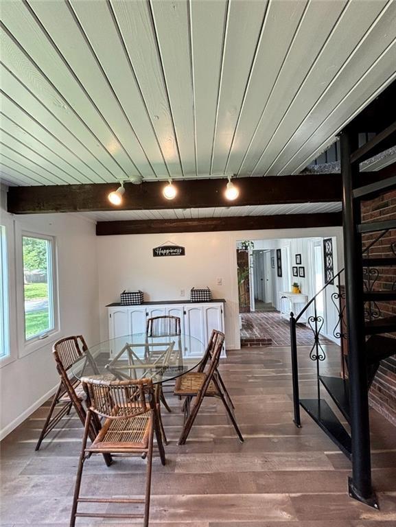 1702 Countryside Dr, Pittsburg, KS 66762 - dining space with wood finished floors, rail lighting, baseboards, and wood ceiling